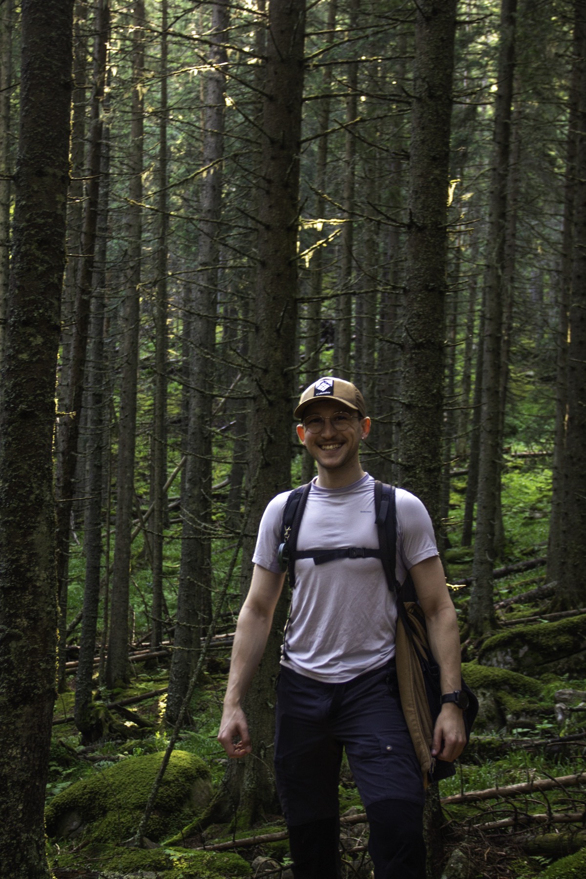 Krisztián hiking through a dense green forest
