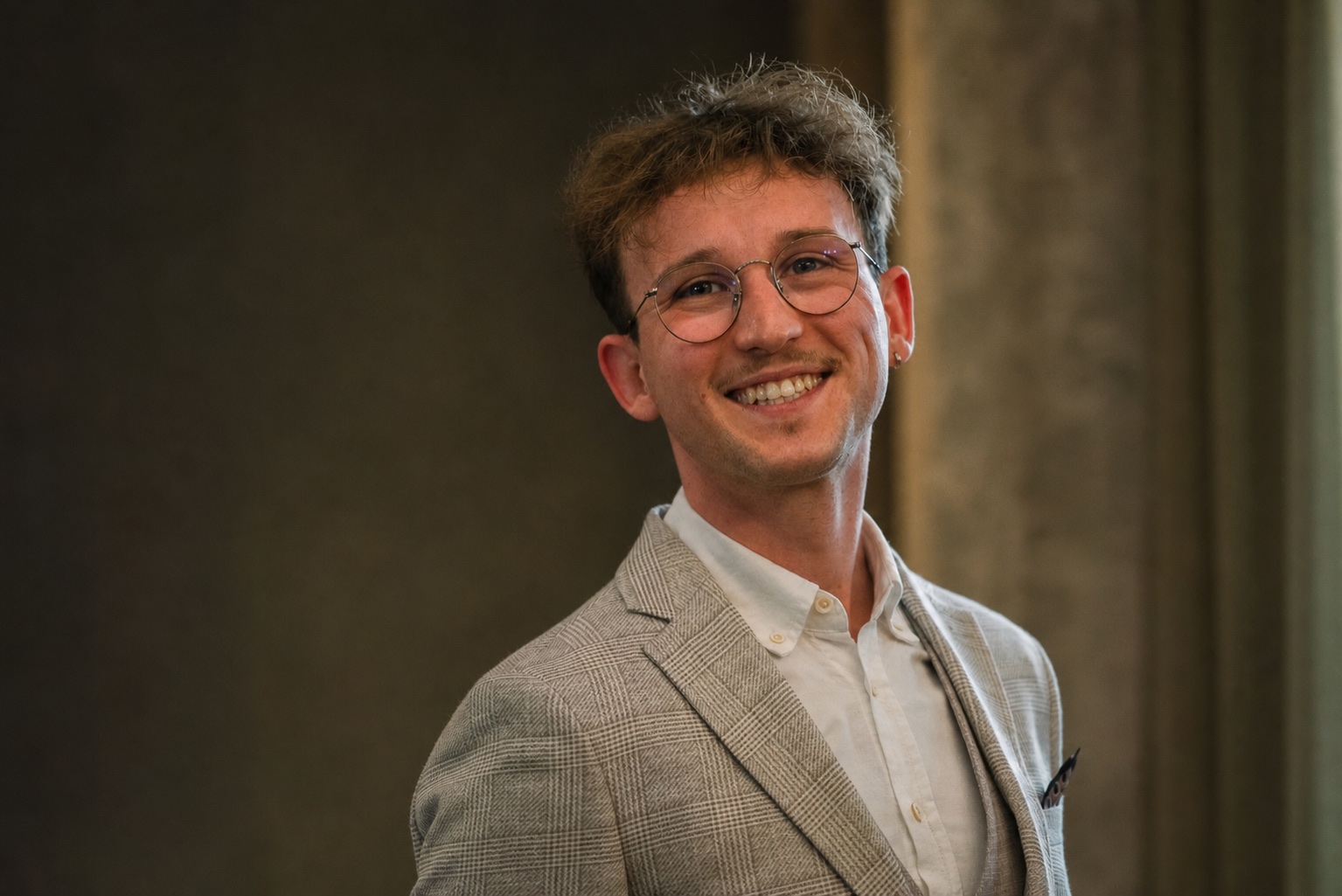 Krisztián Józsa smiling at a professional event