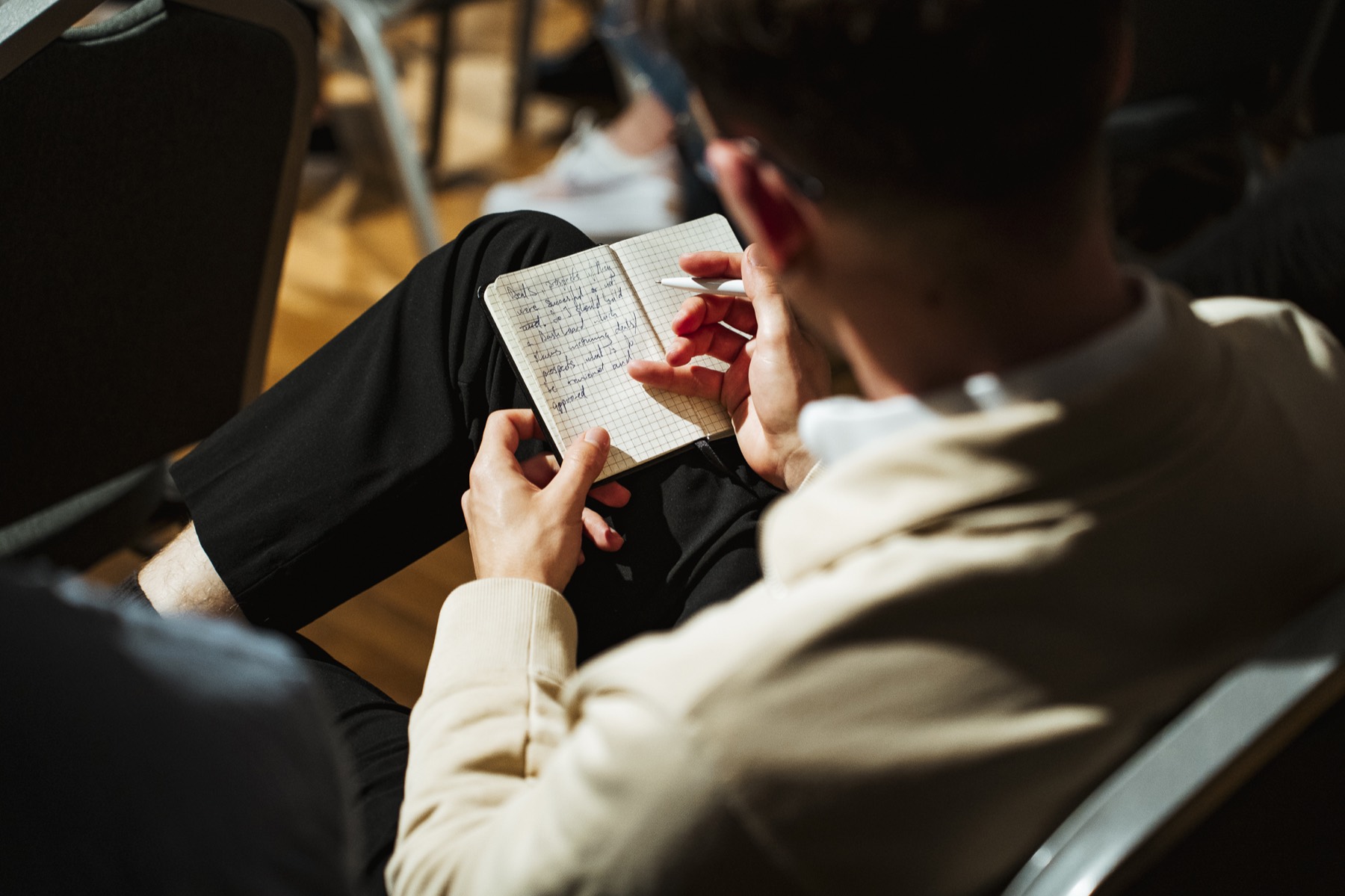 Krisztián writing structured notes during a workshop
